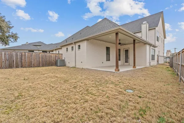 a view of a house with wooden fence