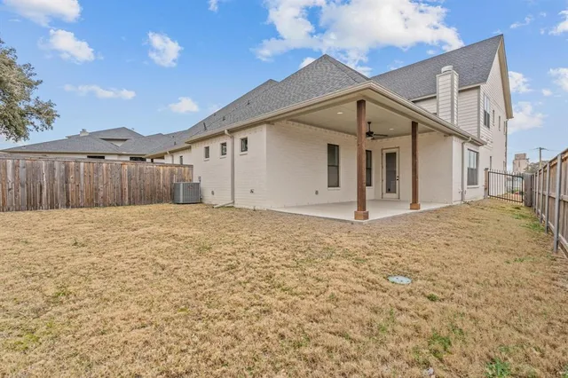 a view of a house with wooden fence