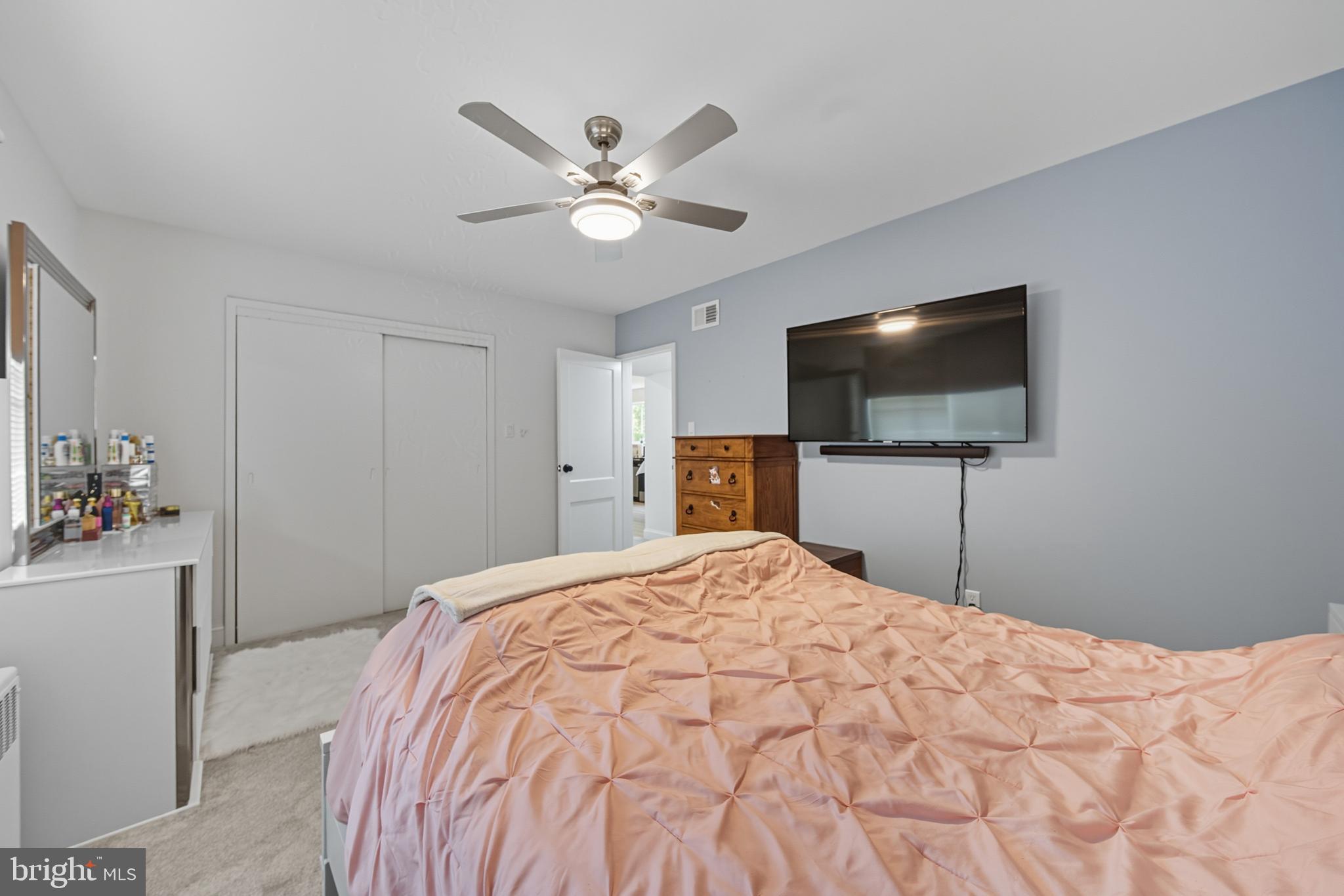 10305 Montrose Avenue, Unit 10305 Bethesda, MD 20814 - Photo 12 of 16 a bedroom with a bed and a flat screen tv