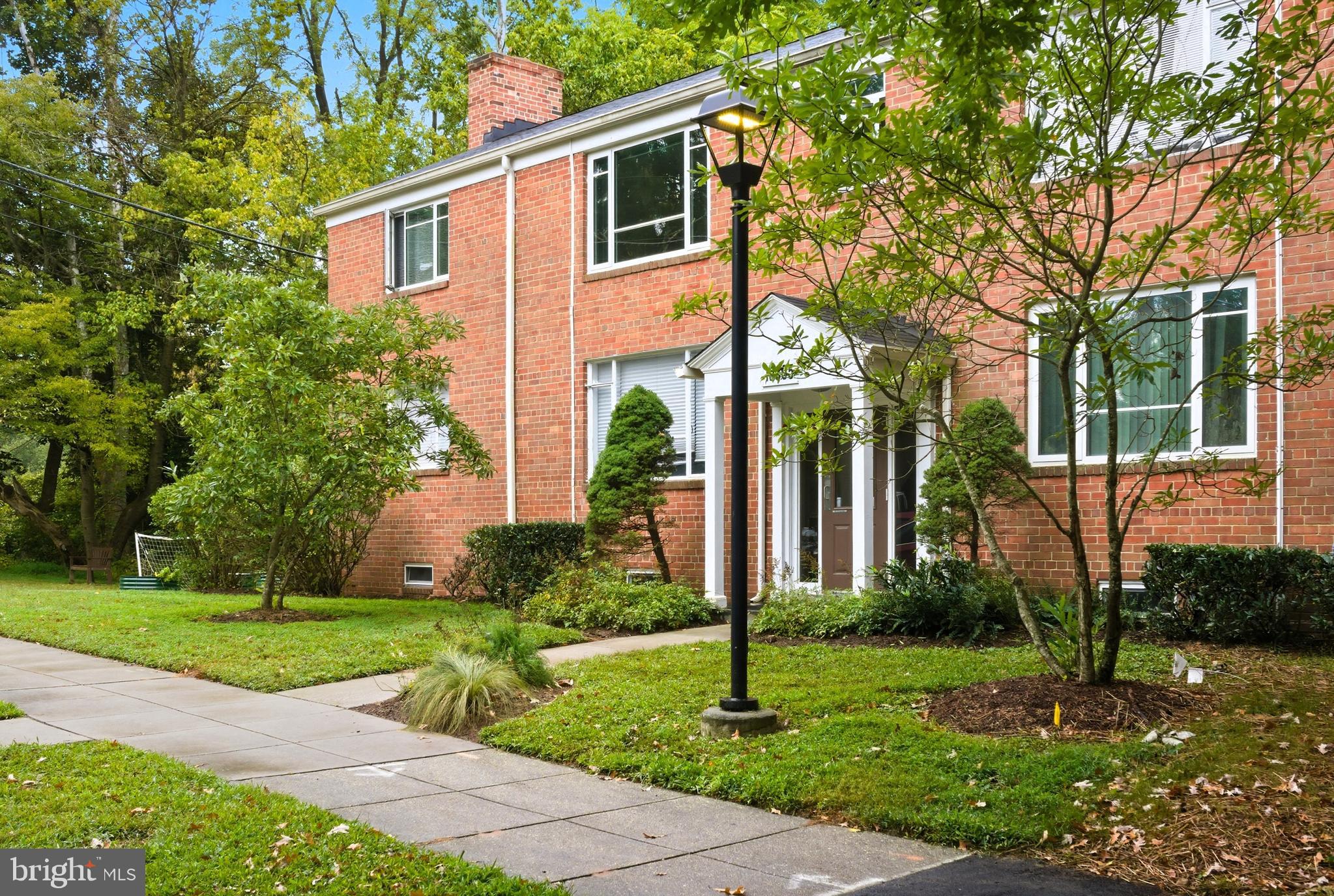10305 Montrose Avenue, Unit 10305 Bethesda, MD 20814 - Photo 2 of 16 a front view of a house with a yard and potted plants