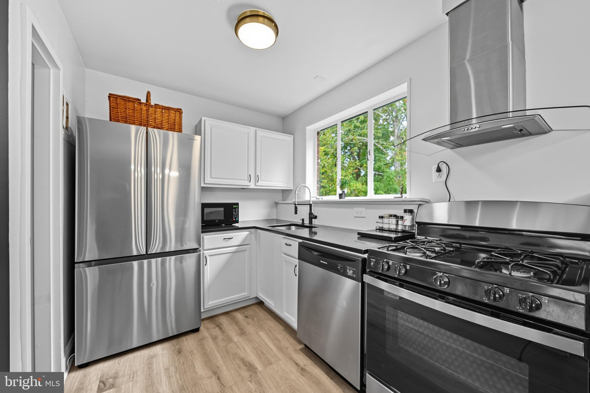 10305 Montrose Avenue, Unit 10305 Bethesda, MD 20814 - Photo 5 of 16 a kitchen with a stove a refrigerator and a window