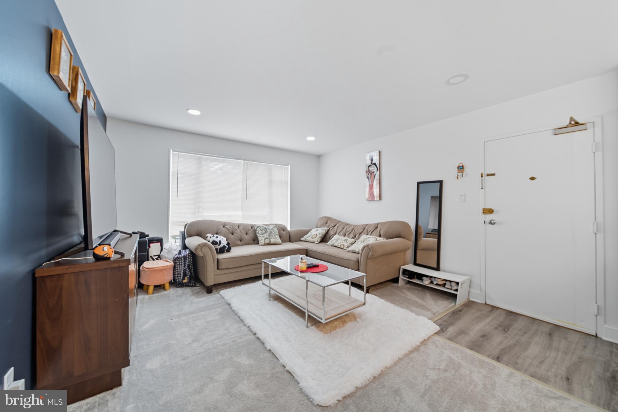 10305 Montrose Avenue, Unit 10305 Bethesda, MD 20814 - Photo 9 of 16 a living room with furniture and a flat screen tv