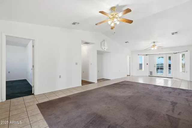 a view of kitchen with windows and refrigerator