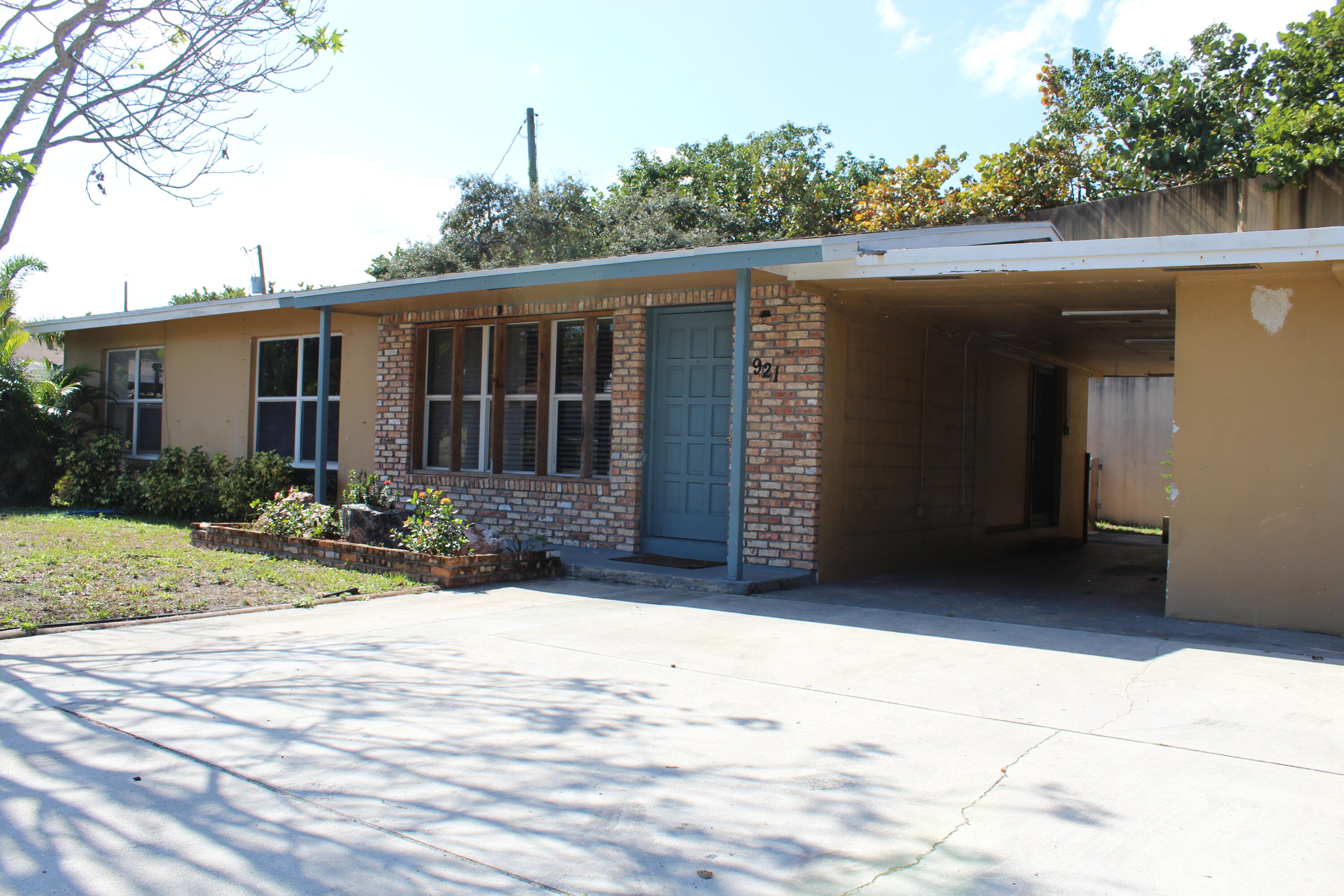 921 Pine Terrace Lake Worth Beach, FL 33460 - Photo 1 of 10 a front view of house with yard and trees in the background