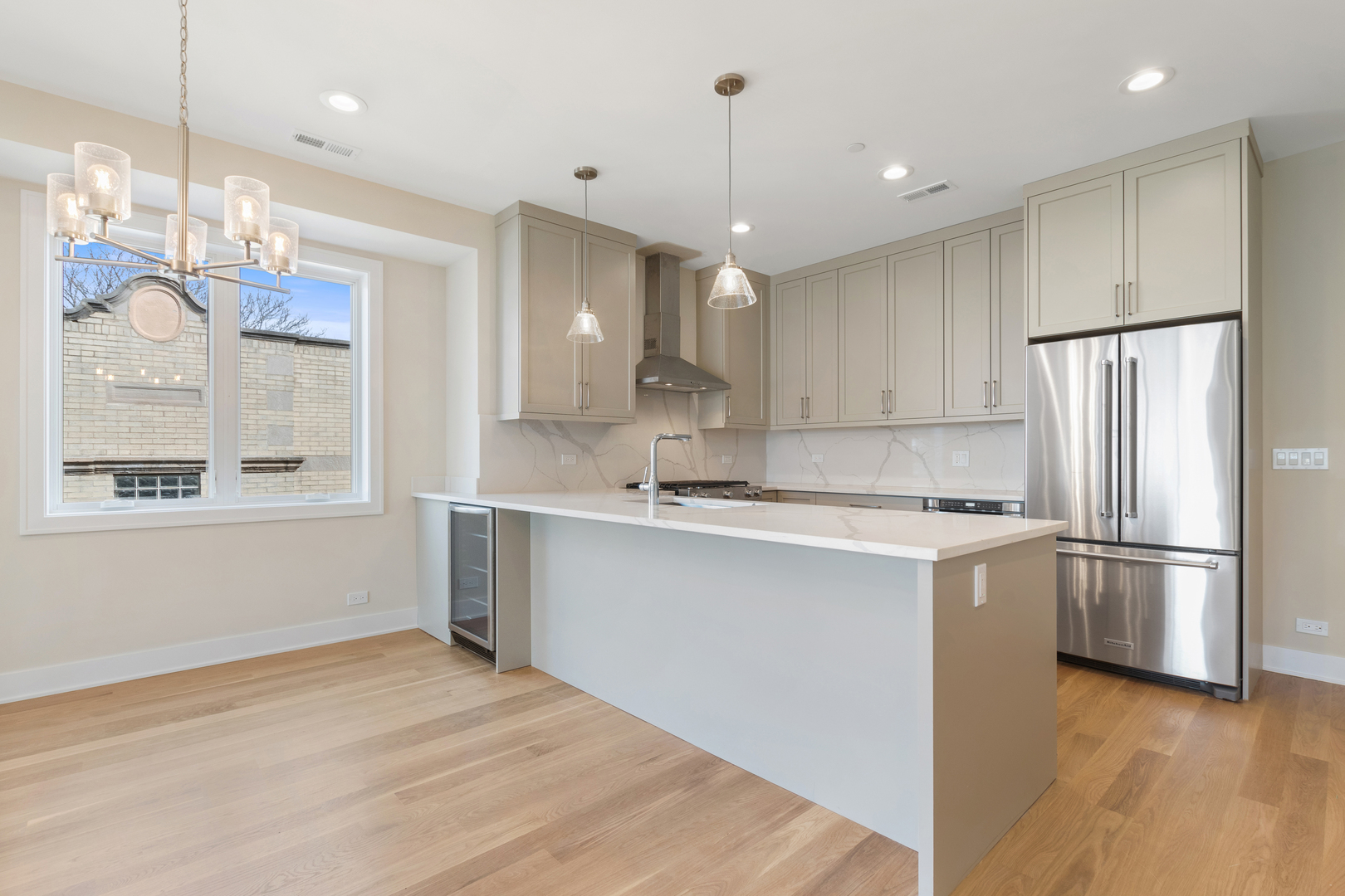 Undisclosed Address Chicago, IL 60640 - Photo 2 of 12 a kitchen with stainless steel appliances granite countertop a refrigerator a sink dishwasher a stove and white cabinets with wooden floor