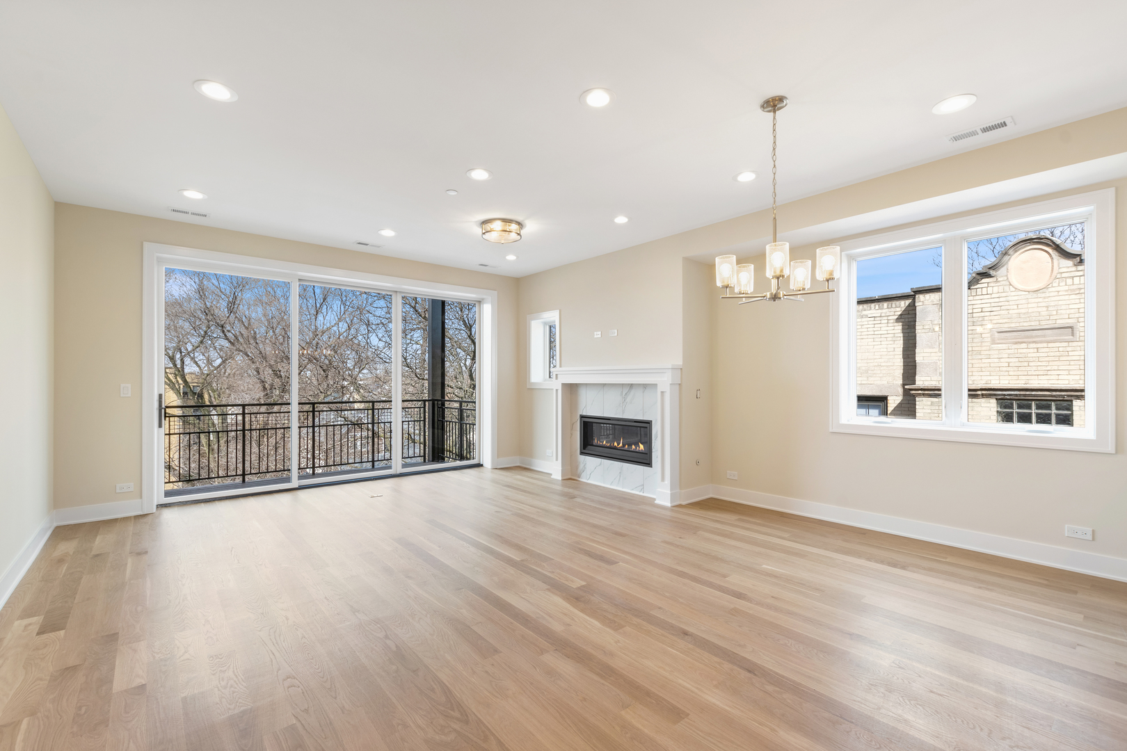 Undisclosed Address Chicago, IL 60640 - Photo 5 of 12 a view of an empty room with a window and wooden floor