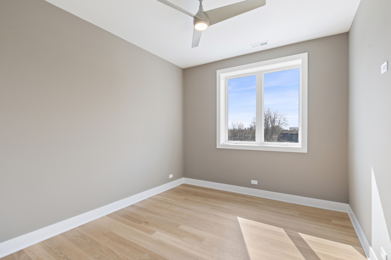 Undisclosed Address Chicago, IL 60640 - Photo 8 of 12 a view of a room with a ceiling fan and a window