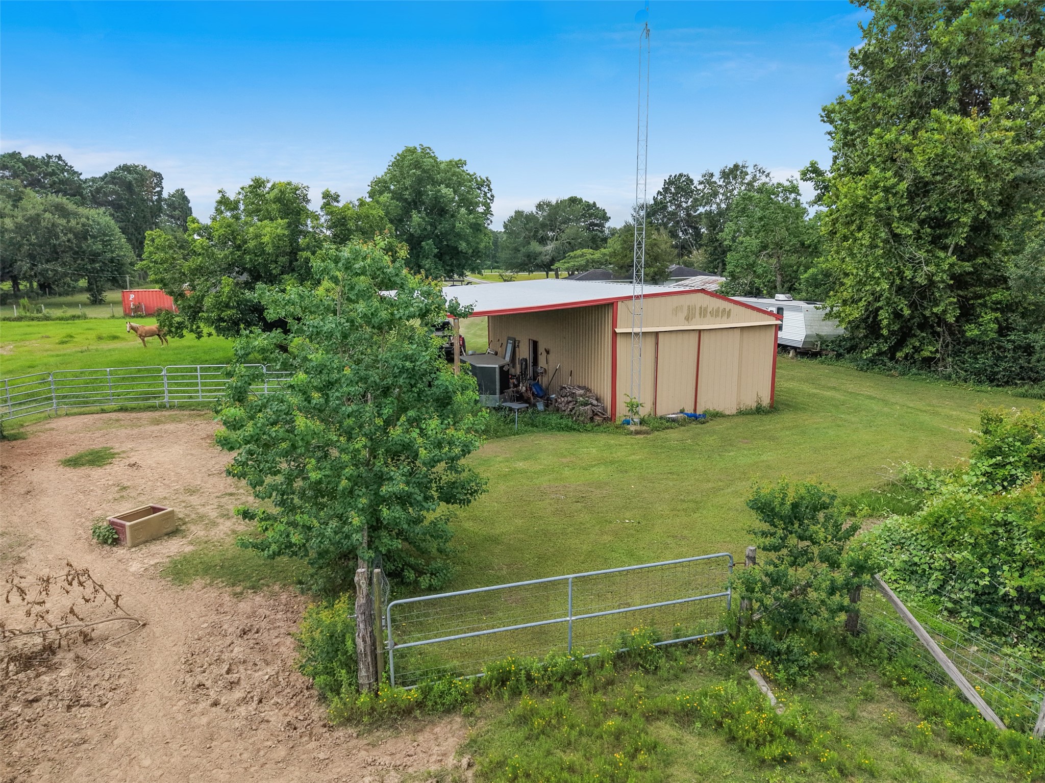34366 Owens Road Hempstead, TX 77445 - Photo 37 of 46 Large fenced backyard featuring mature shade trees, a storage shed, and ample open space for gardening, recreation, pets, or future improvements.