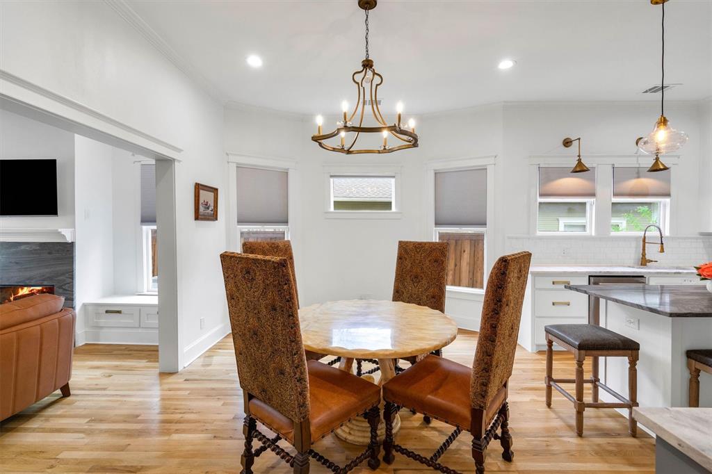 5727 Victor Street Dallas, TX 75214 - Photo 12 of 40 a view of a dining room with furniture a chandelier and wooden floor
