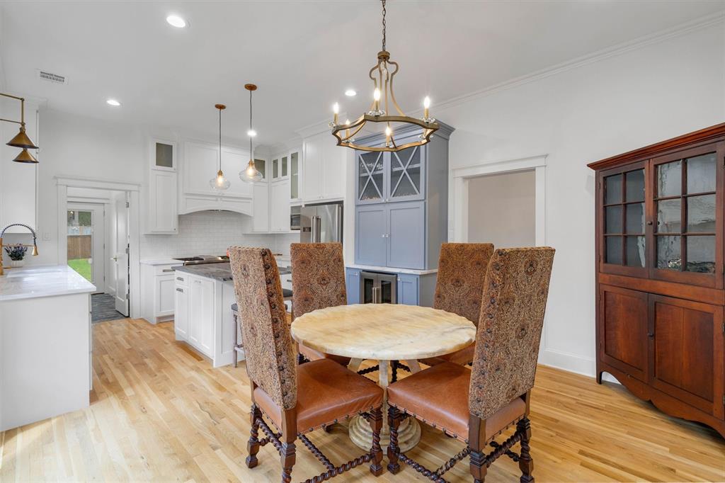 5727 Victor Street Dallas, TX 75214 - Photo 13 of 40 a view of a dining room with furniture window and wooden floor