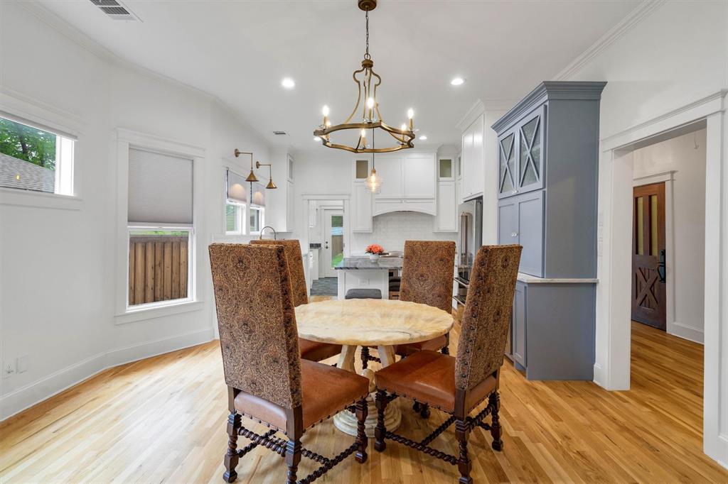 5727 Victor Street Dallas, TX 75214 - Photo 14 of 40 a view of a dining room with furniture window and wooden floor