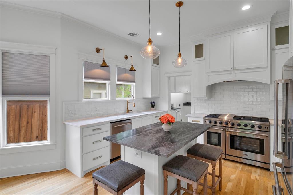 5727 Victor Street Dallas, TX 75214 - Photo 18 of 40 a kitchen with stainless steel appliances granite countertop a stove a sink and a refrigerator