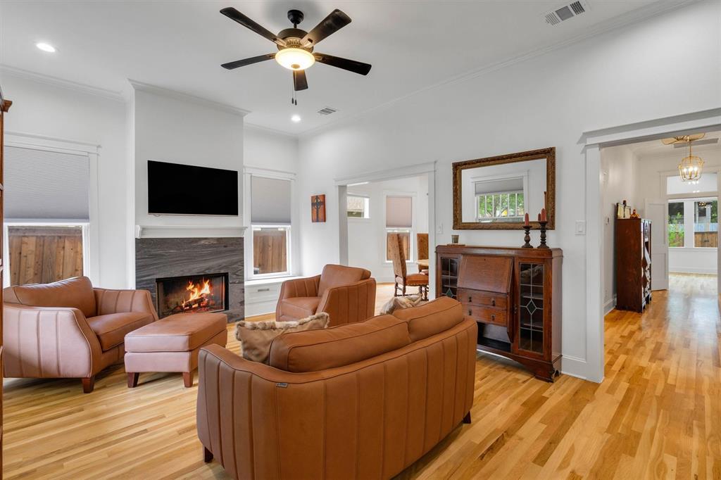 5727 Victor Street Dallas, TX 75214 - Photo 2 of 40 a living room with furniture a fireplace and a flat screen tv