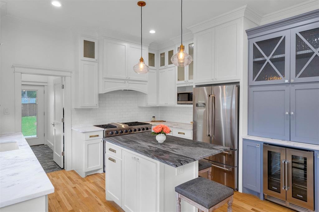 5727 Victor Street Dallas, TX 75214 - Photo 21 of 40 a kitchen with stainless steel appliances granite countertop a stove a refrigerator and a sink