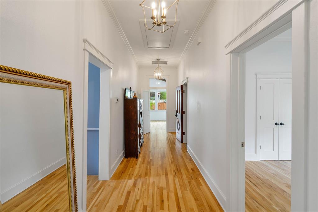 5727 Victor Street Dallas, TX 75214 - Photo 23 of 40 a view of a hallway with wooden floor and staircase