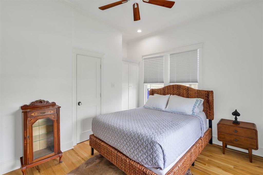 5727 Victor Street Dallas, TX 75214 - Photo 25 of 40 a bedroom with a bed and wooden floor