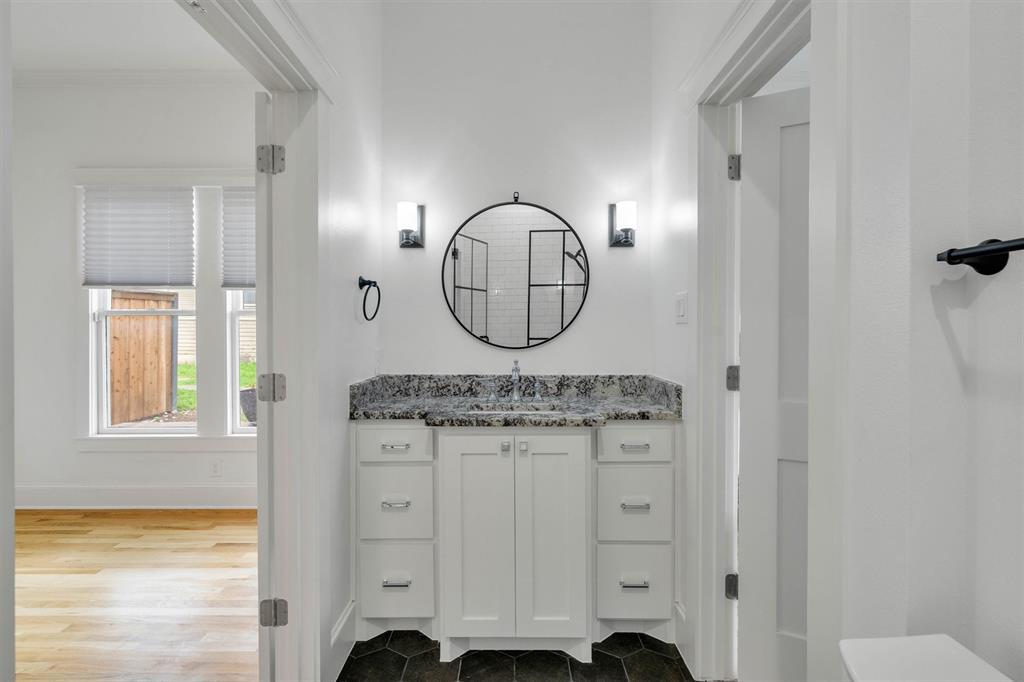 5727 Victor Street Dallas, TX 75214 - Photo 27 of 40 a bathroom with a sink a mirror and a shower