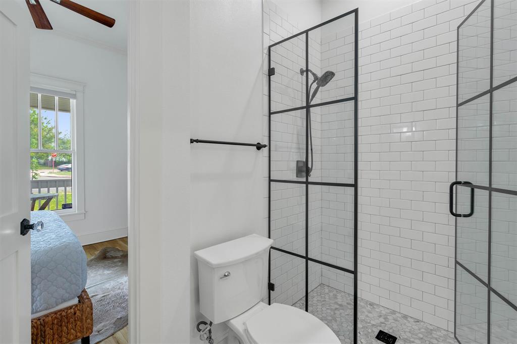 5727 Victor Street Dallas, TX 75214 - Photo 28 of 40 a bathroom with a toilet and a shower