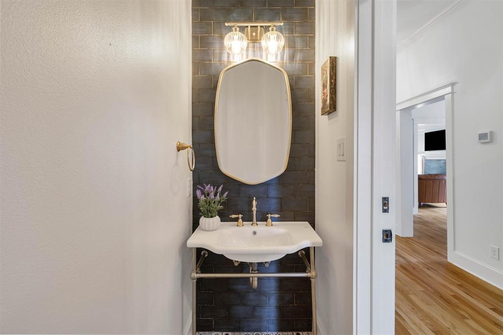 5727 Victor Street Dallas, TX 75214 - Photo 30 of 40 a bathroom with a sink and a mirror