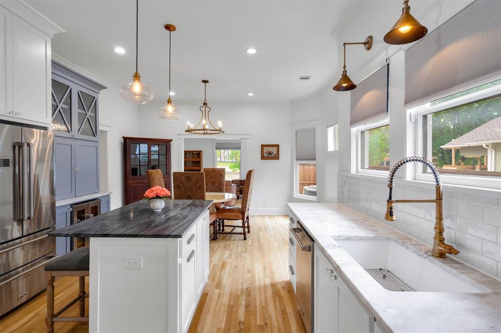 5727 Victor Street Dallas, TX 75214 - Photo 3 of 40 a kitchen with stainless steel appliances granite countertop sink stove and refrigerator