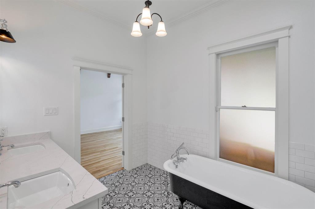 5727 Victor Street Dallas, TX 75214 - Photo 32 of 40 a bathroom with a sink a toilet and shower