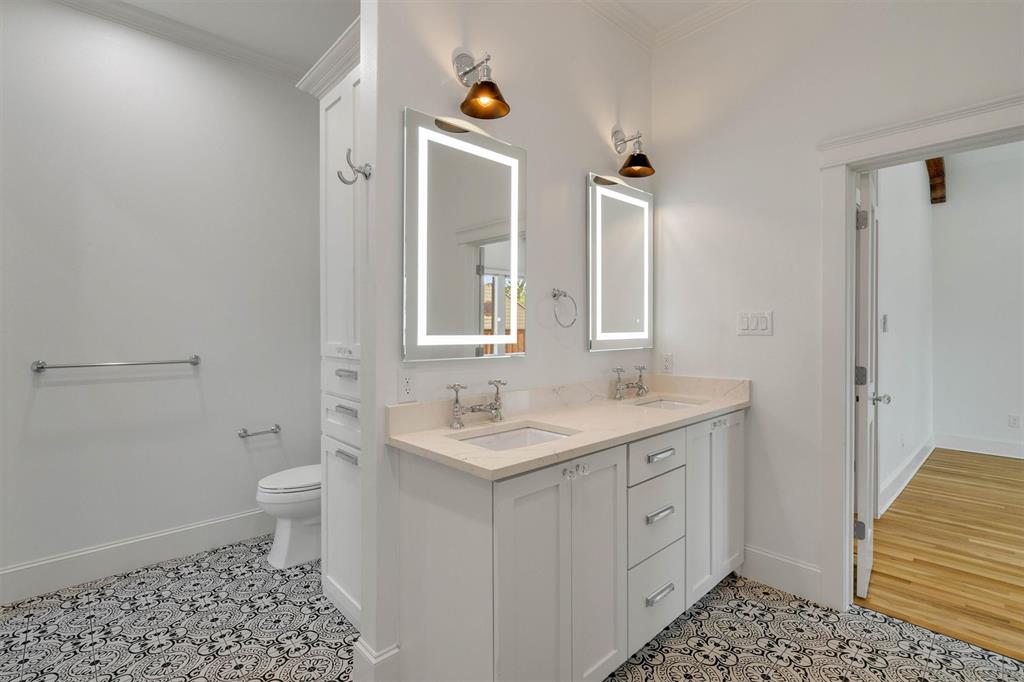 5727 Victor Street Dallas, TX 75214 - Photo 34 of 40 a bathroom with a sink a toilet a shower and a mirror