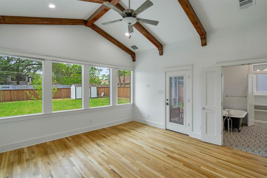 5727 Victor Street Dallas, TX 75214 - Photo 4 of 40 a view of an empty room with a window and wooden floor