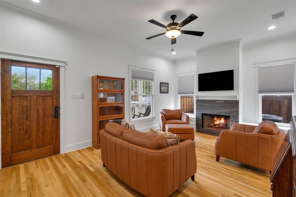5727 Victor Street Dallas, TX 75214 - Photo 9 of 40 a living room with furniture a fireplace and a flat screen tv