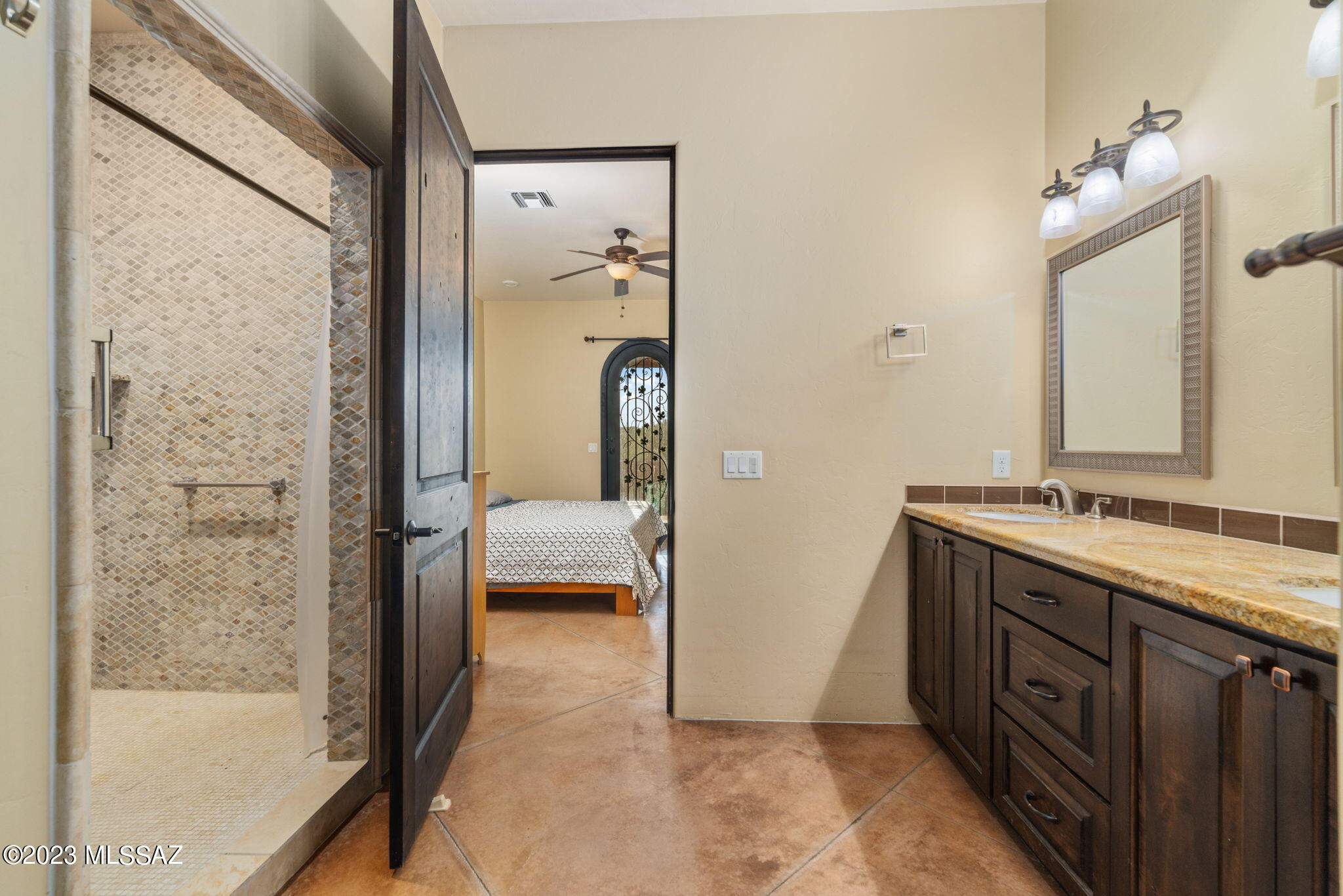 5670 Triangle X Place Tucson, AZ 85713 - Photo 14 of 36 a bathroom with a granite countertop sink a mirror and a bathtub