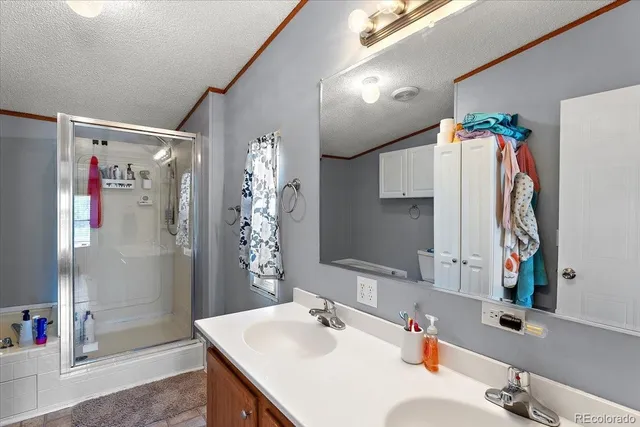 a bathroom with a sink vanity tub and shower