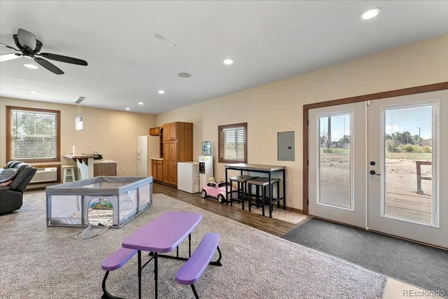 a living room with furniture a dining table and chairs with kitchen view