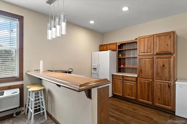 a kitchen with stainless steel appliances a refrigerator and a stove top oven