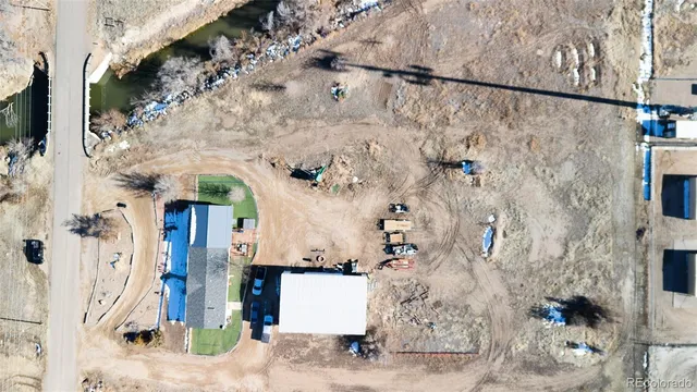 a front view of a house with a tree