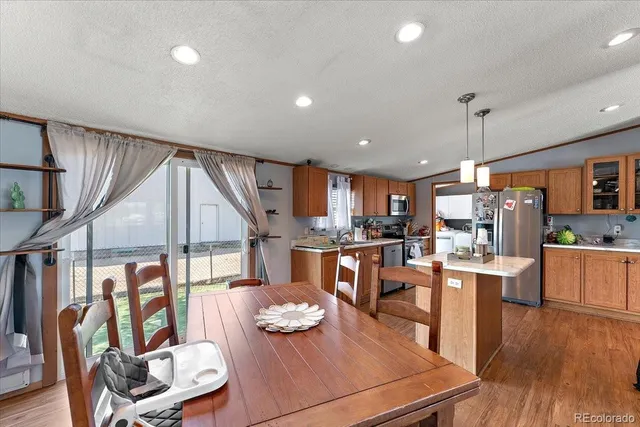 a living room with lots of furniture and kitchen view