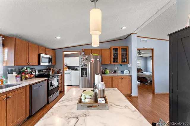 a kitchen with a refrigerator and a sink