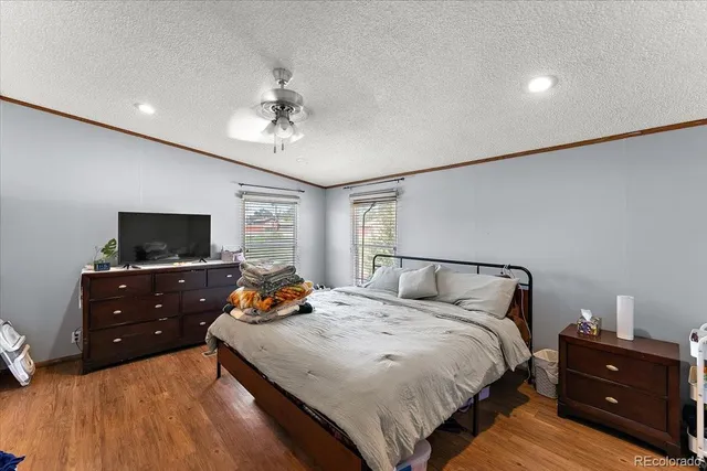 a bedroom with a bed and a television