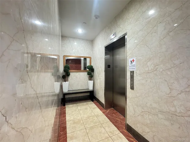 a bathroom with a glass door shower and a sink