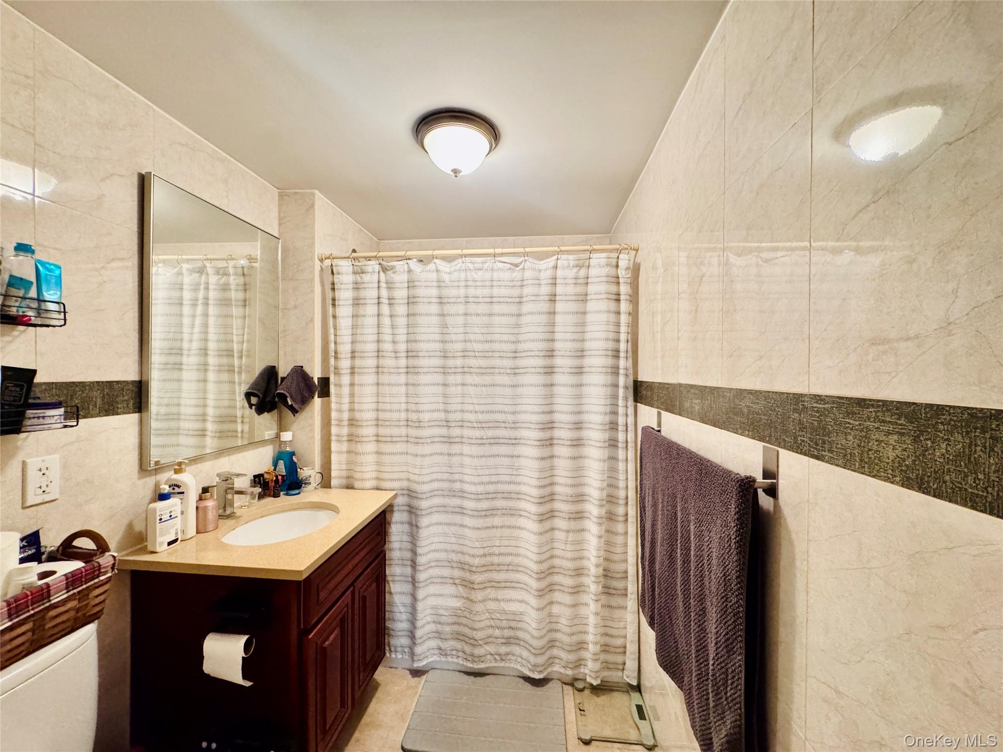 37-49 81st Street, Unit 3A Queens, NY 11372 - Photo 18 of 20 a bathroom with a sink and a mirror