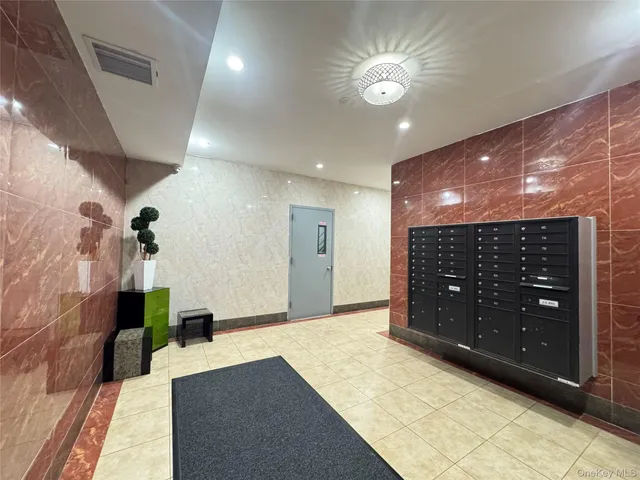 a spacious bathroom with a granite countertop sink a large mirror and a shower