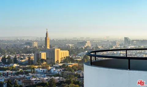 a kitchen with granite countertop a sink a counter top space cabinets and stainless steel appliances