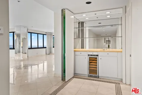 a kitchen with white cabinets and appliances