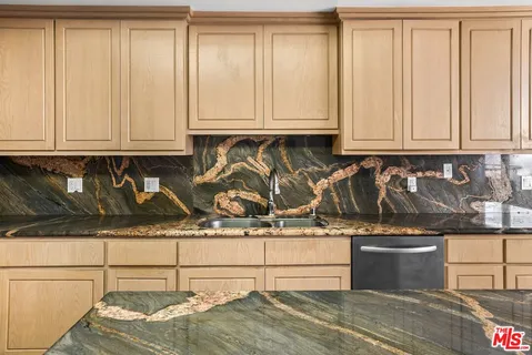 a kitchen with a refrigerator and mirror