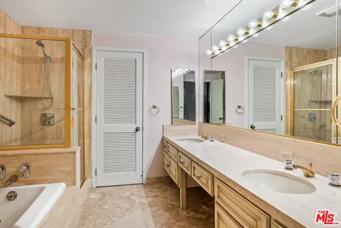 a spacious bathroom with a granite countertop bathtub shower sink vanity and toilet