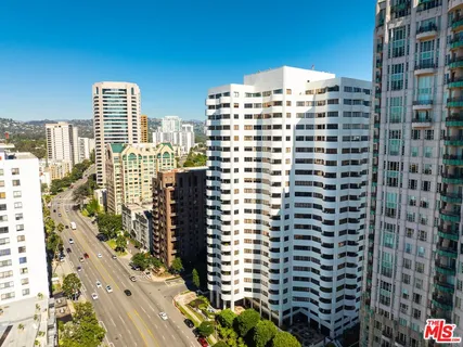 a front view of a building with sitting area