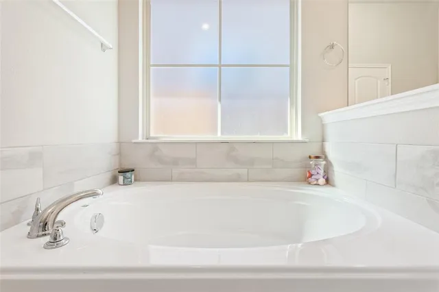 a white bath tub sitting next to a window