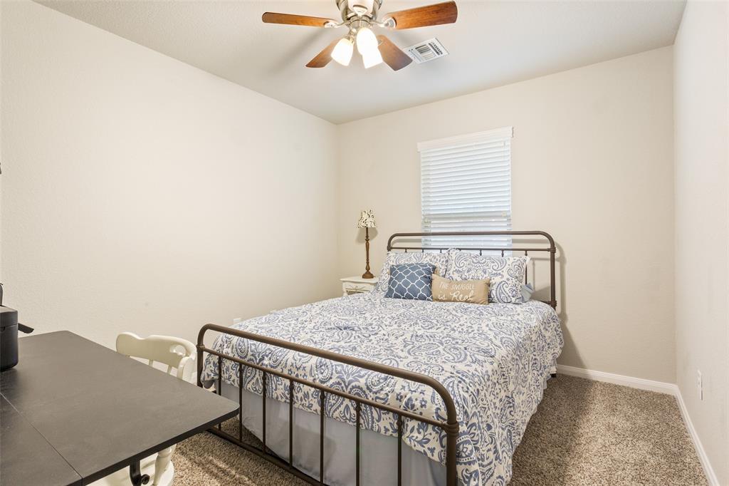 10204 Driskill Drive Waco, TX 76708 - Photo 21 of 30 a bedroom with a bed and a table