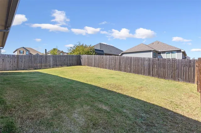 a view of swimming pool with wooden fence