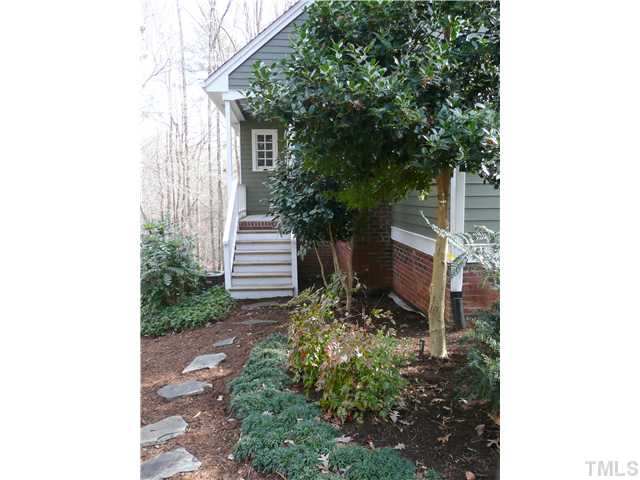 10300 Whitestone Road Raleigh, NC 27615 - Photo 22 of 25 Pretty entrance on the left side of the home that opens into the hall to laundry room and then family room Facade/Exterior Front