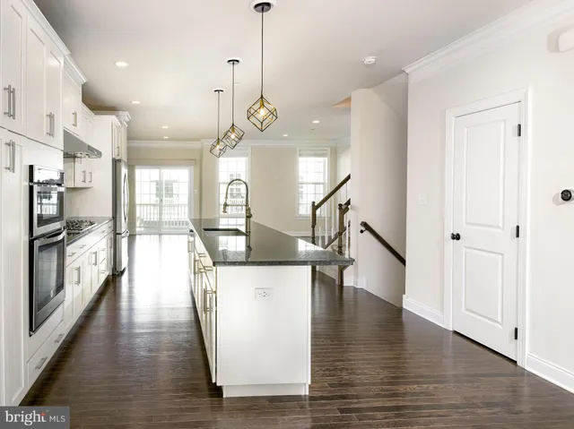 a view of a kitchen with wooden floor and a large window
