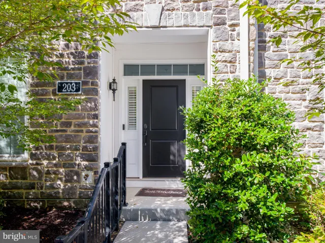 a front view of a house with a tree